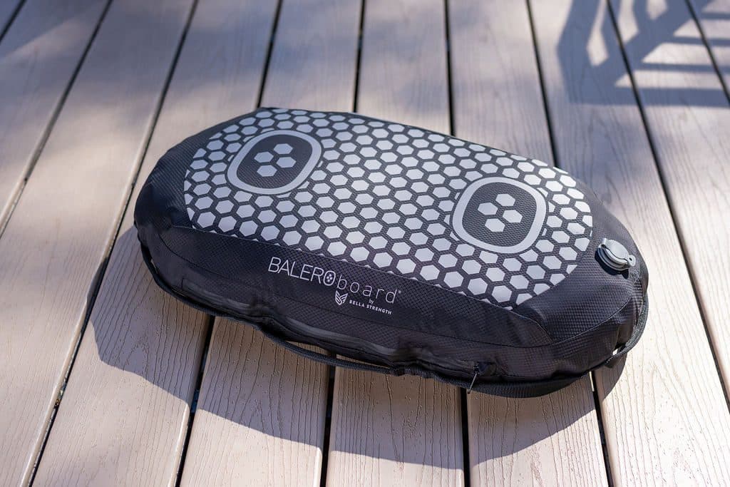 A fully inflated BALEROboard sitting flat and still on a sunlit deck