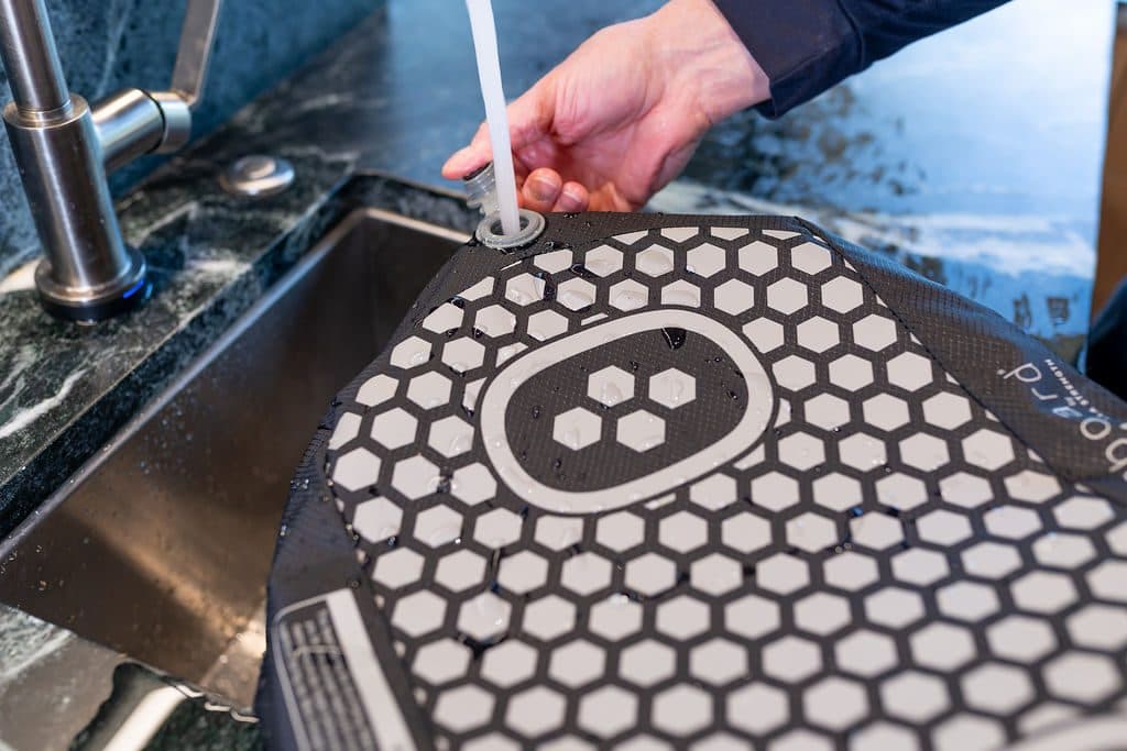 Rinsing the BALEROboard cover in a sink